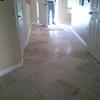 Half wall removed to open flow of floor plan. Travertine tile installed on a diagonal